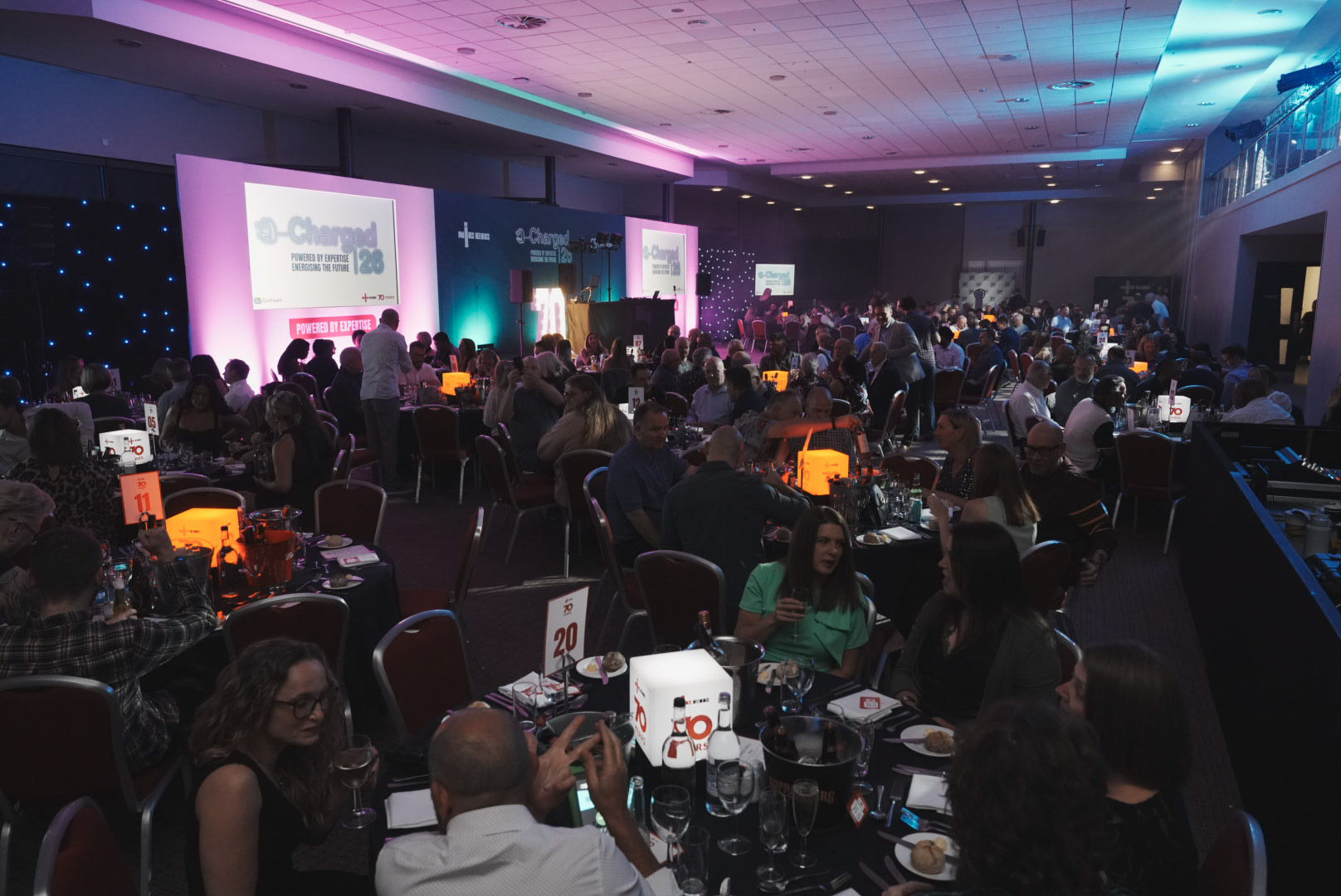 Evening dinner with glowing NICEIC 70 years table centrepieces