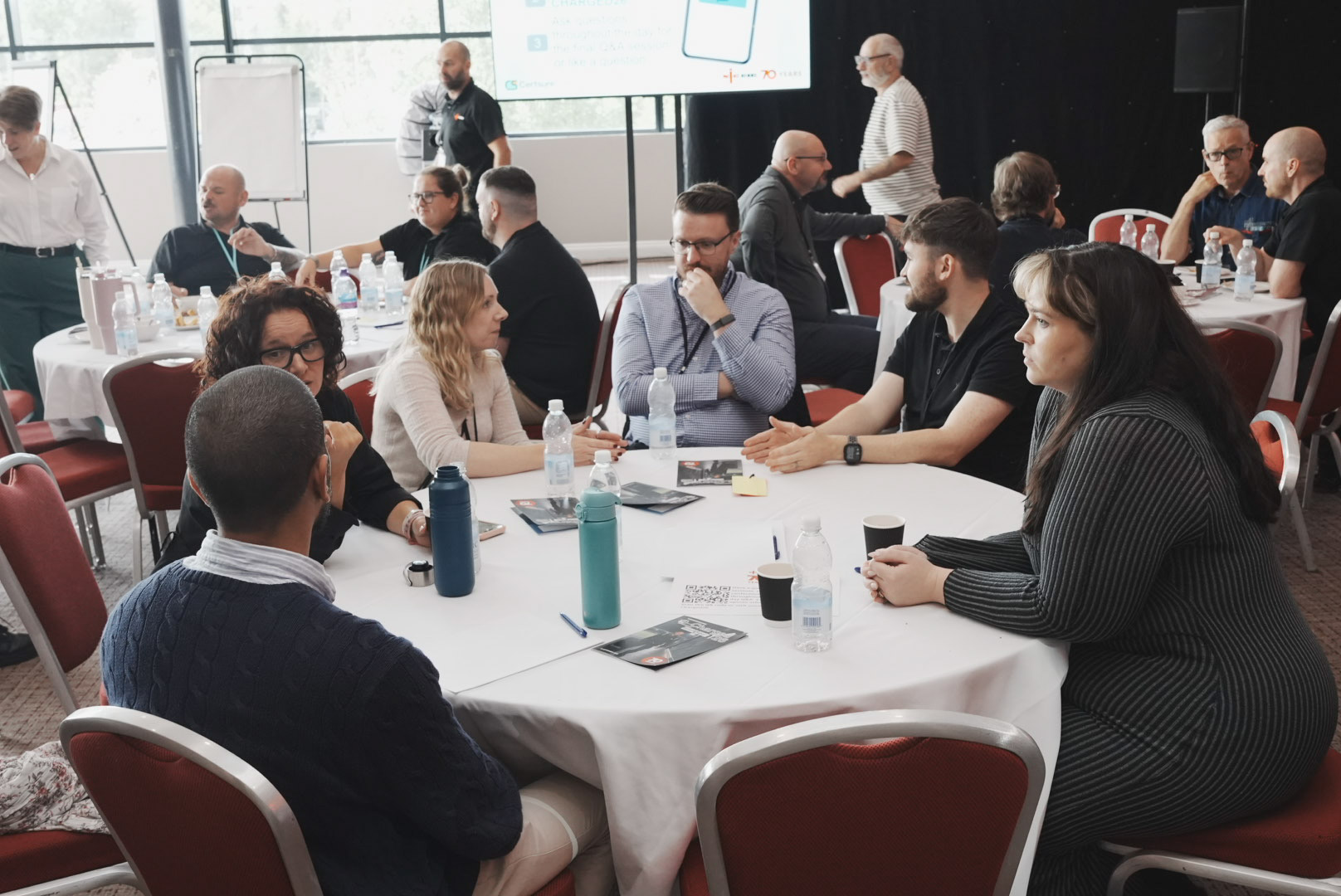 Delegates collaborating in a roundtable breakout session