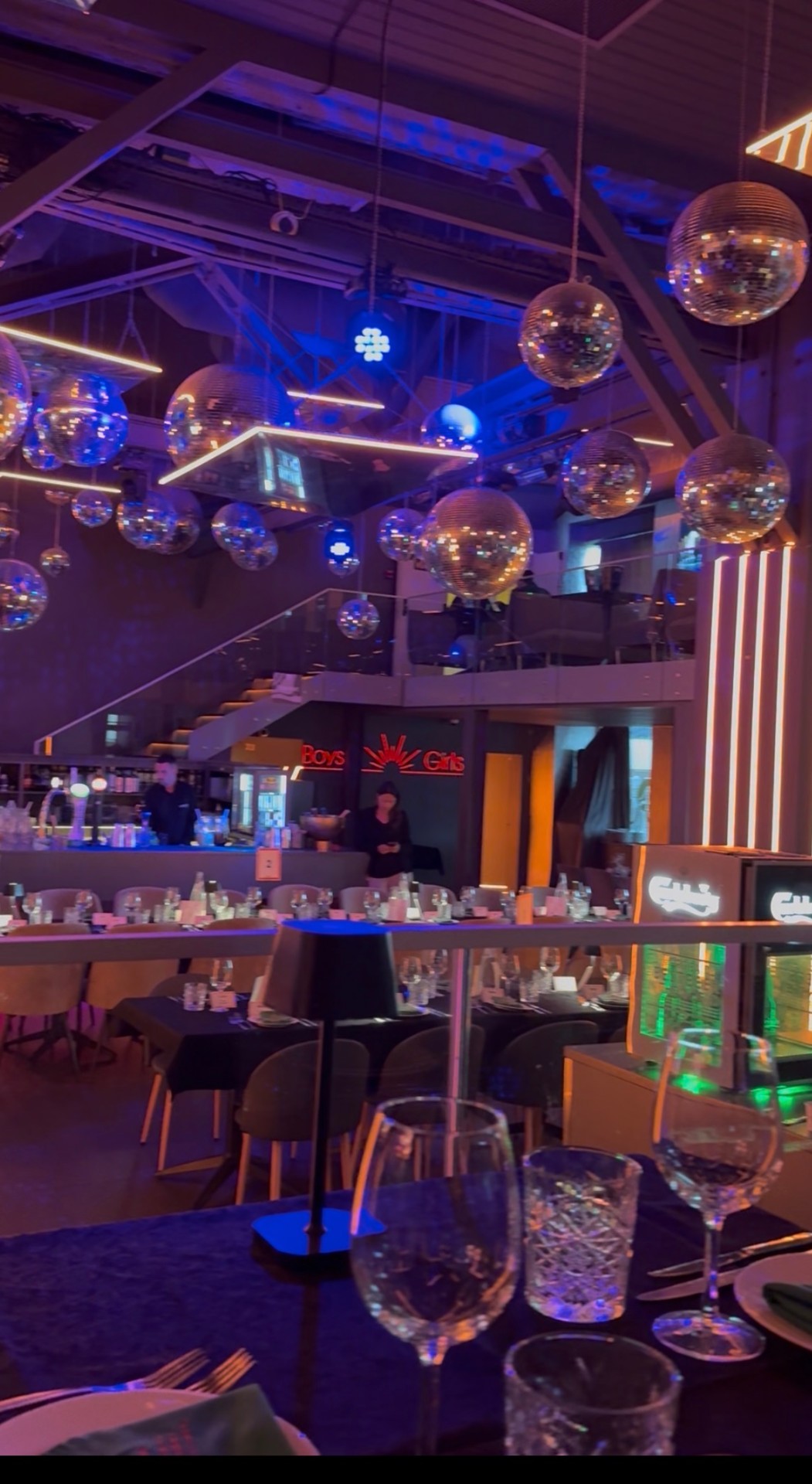 Group dinner venue dressed with disco balls and ambient lighting