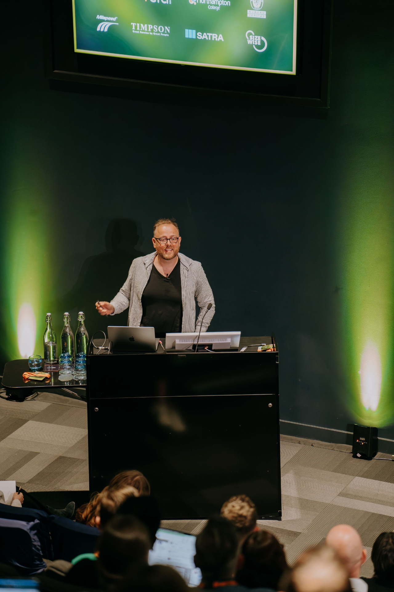 Guest speaker presenting from the summit podium