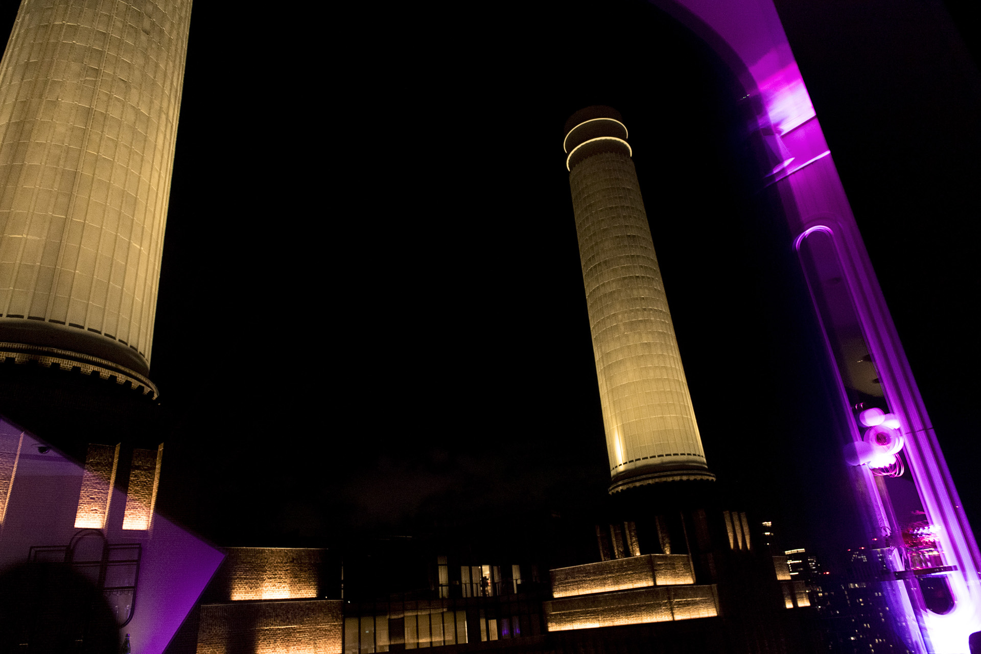 Battersea Power Station chimneys lit up at night