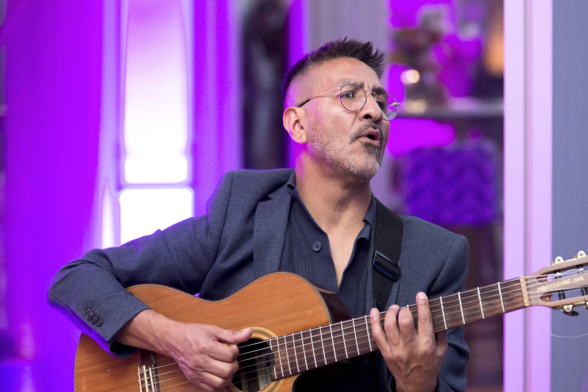 Live acoustic entertainment under purple lighting