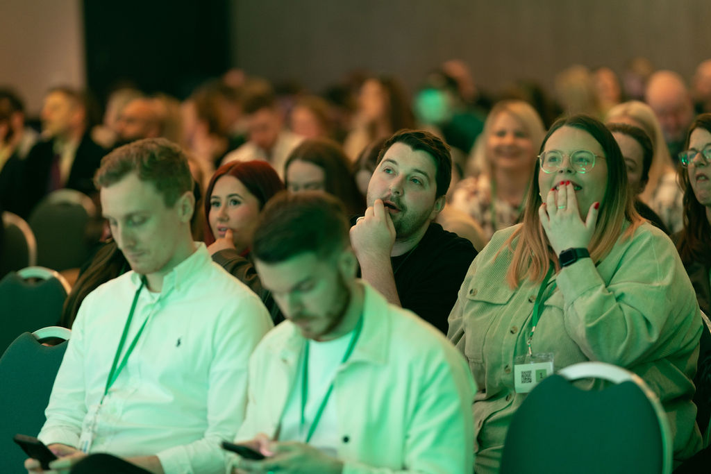 Engaged audience under green stage lighting
